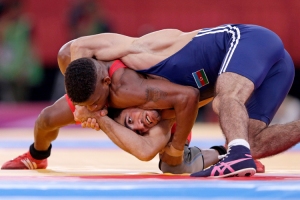 Cuba's Livan Lopez Azcuy fights with Azerbaijan's Jabrayil Hasanov for the bronze medal of the Men's 66Kg Freestyle wrestling at the ExCel venue during the London 2012 Olympic Games
